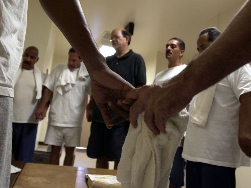 Inmates at Prince George's County Department of Corrections in Maryland participate in a historic baptism ceremony organized by Moving Forward Ministries