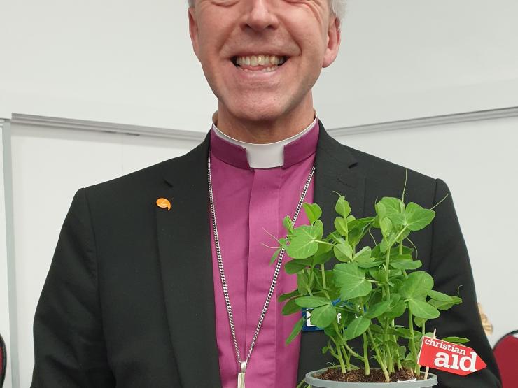 Archbishop Andrew John with a pea plant.jpg