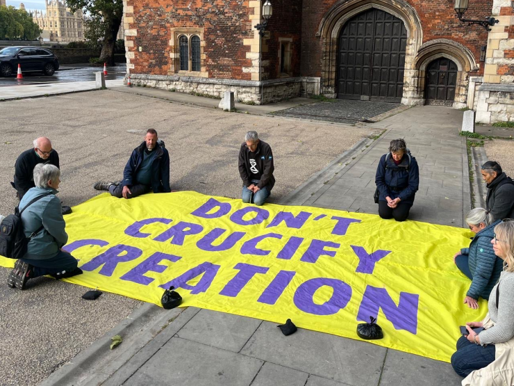 Christian Climate Action members kneeling in prayer outside Lambeth Palace.jpg