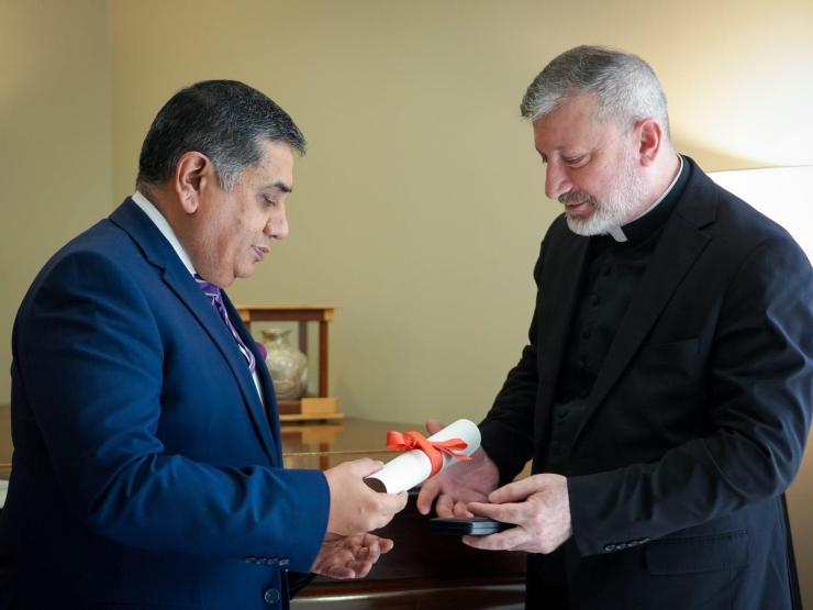 Rev Jerjes receiving MBE and certificate.JPG
