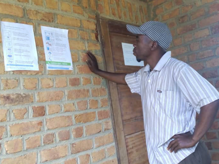 Wycliffe man reading the Bhele posters 1 header 2.jpg