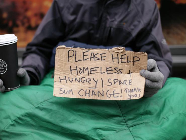 homeless-man-holding-a-sign-asking-for-help_galleryfull.jpg