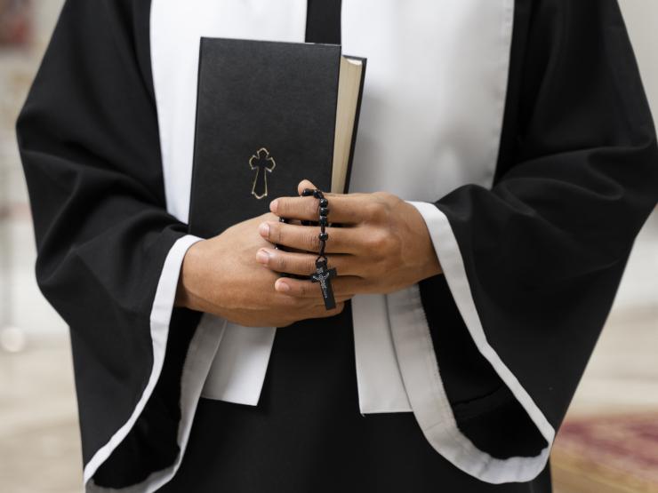 front-view-senior-priest-church-with-bible-freepik.jpg