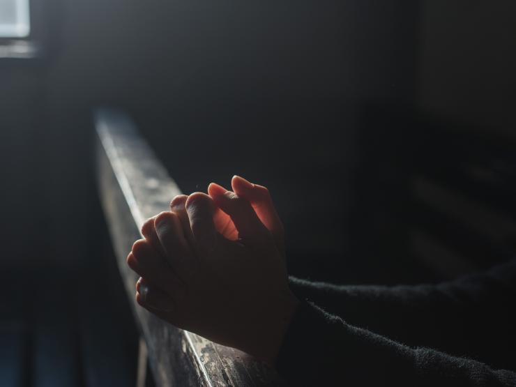 praying hands church dark.jpg