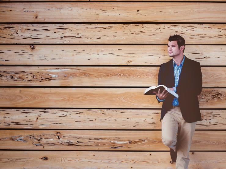 man holding book bible preacher Image by StockSnap from Pixabay.jpg