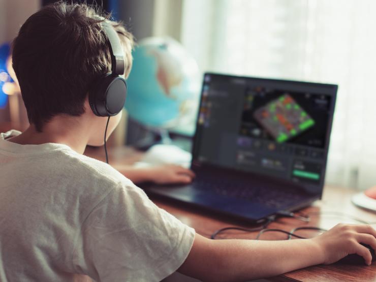 Child with headphones on computer.jpg