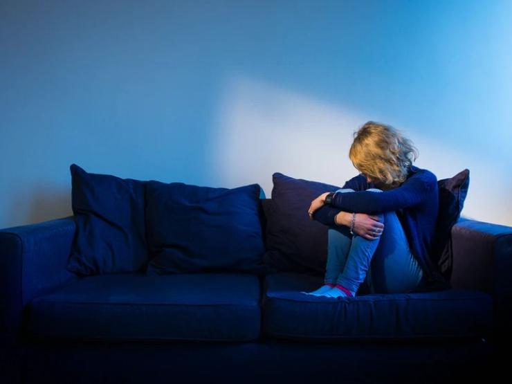 woman on sofa depression PA Wire Dominic Lipinski.jpg