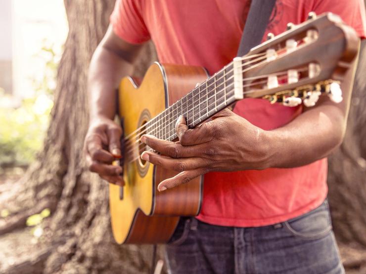 Black man playing guitar outside Image by Ryan McGuire from Pixabay.jpg